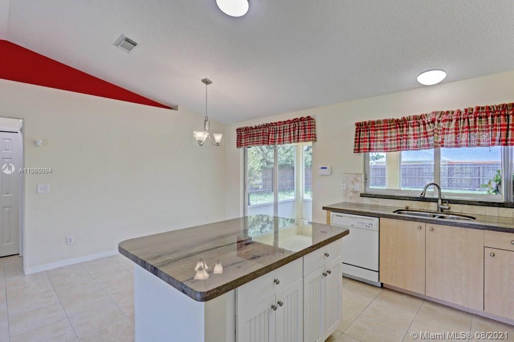 918 Southwest Longfellow Road, Unit 918 Port St. Lucie, FL 34953 - Photo 19 of 53 a kitchen with a sink and cabinets