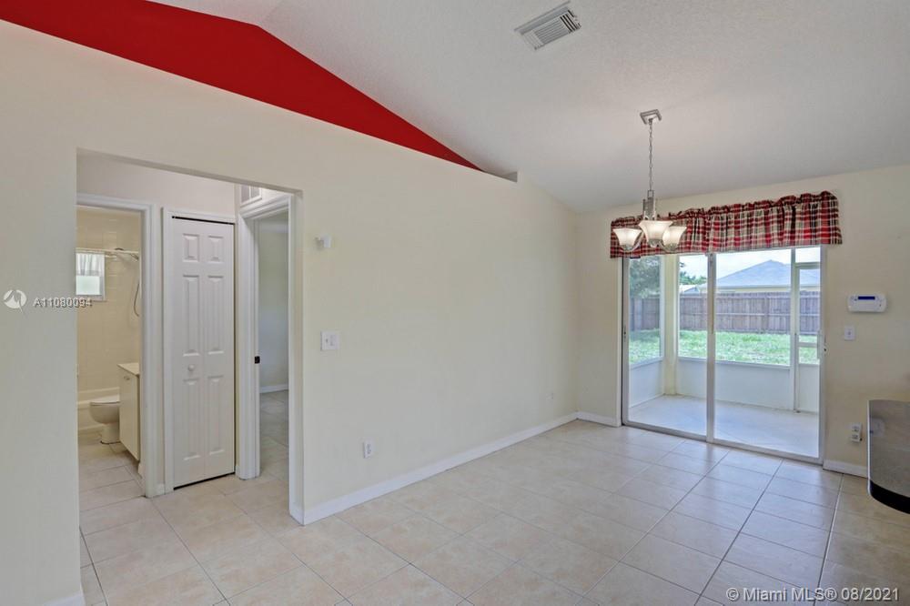 918 Southwest Longfellow Road, Unit 918 Port St. Lucie, FL 34953 - Photo 20 of 53 a view of an empty room with window and cabinet