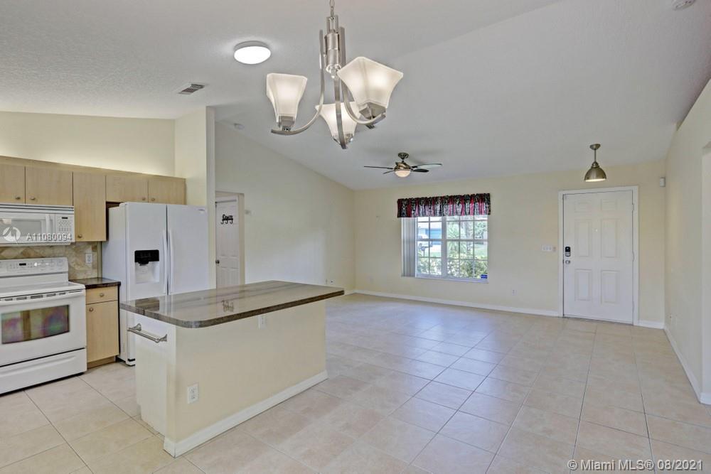 918 Southwest Longfellow Road, Unit 918 Port St. Lucie, FL 34953 - Photo 22 of 53 a view of a kitchen with a sink and chandelier