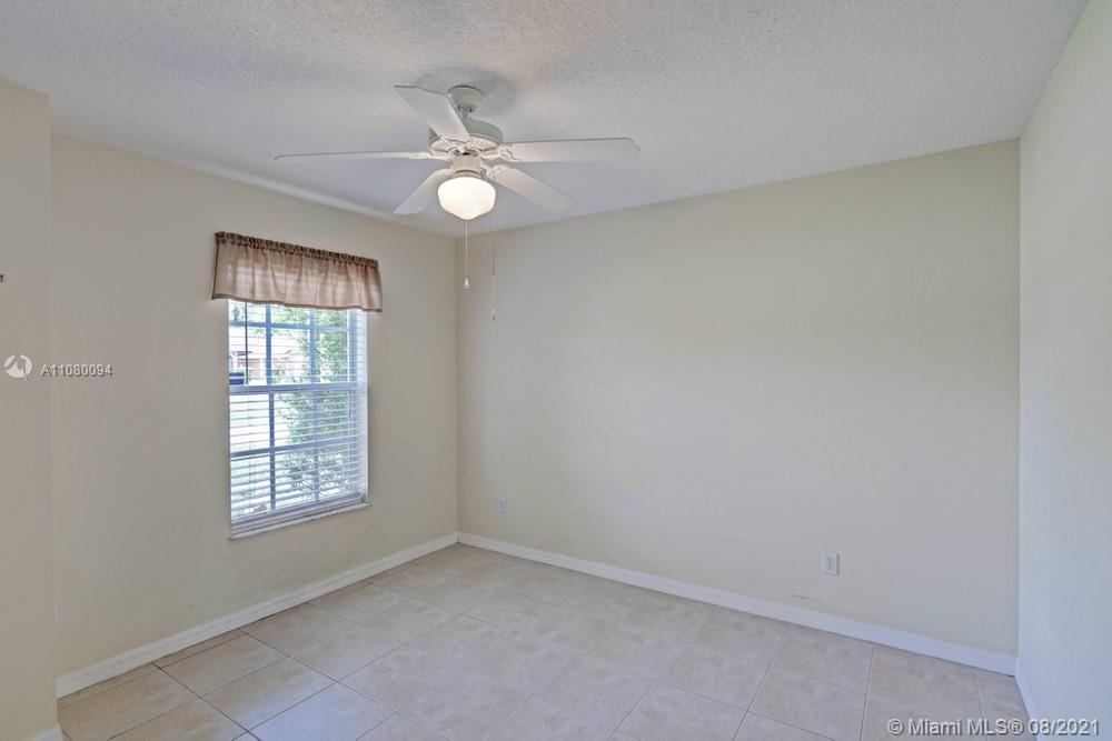 918 Southwest Longfellow Road, Unit 918 Port St. Lucie, FL 34953 - Photo 24 of 53 an empty room with a window and a fan