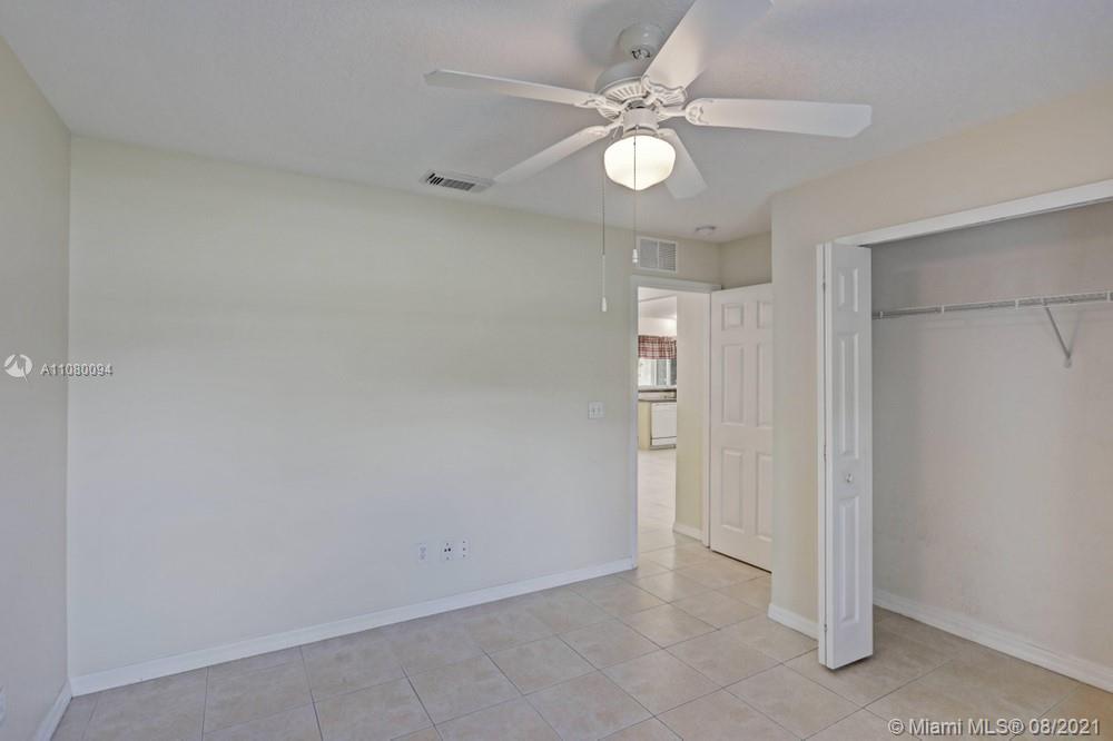 918 Southwest Longfellow Road, Unit 918 Port St. Lucie, FL 34953 - Photo 26 of 53 an empty room with a ceiling fan and a window