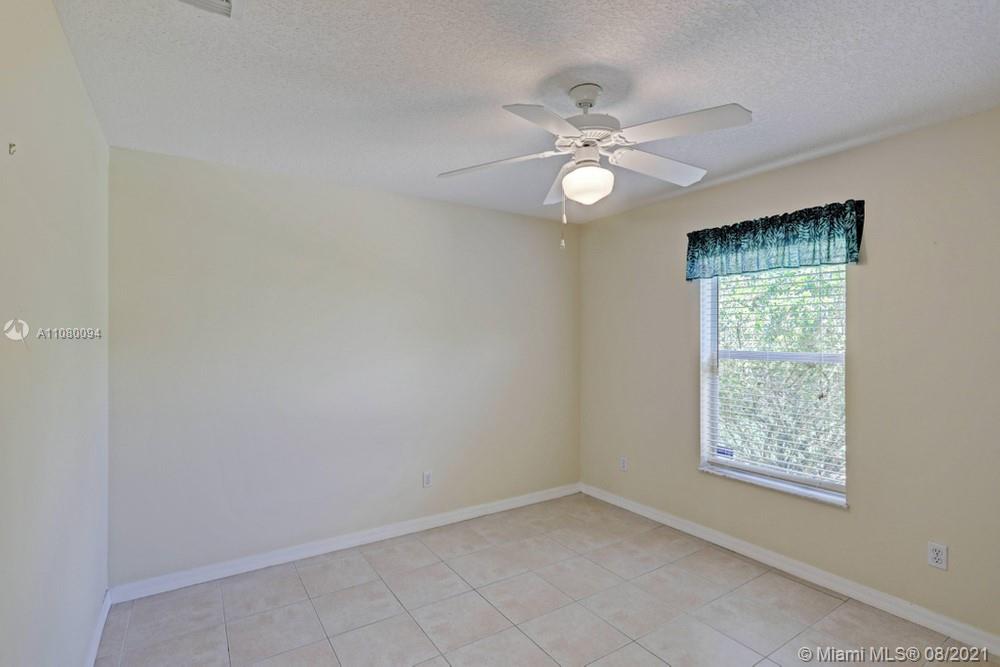 918 Southwest Longfellow Road, Unit 918 Port St. Lucie, FL 34953 - Photo 27 of 53 an empty room with a window and a fan