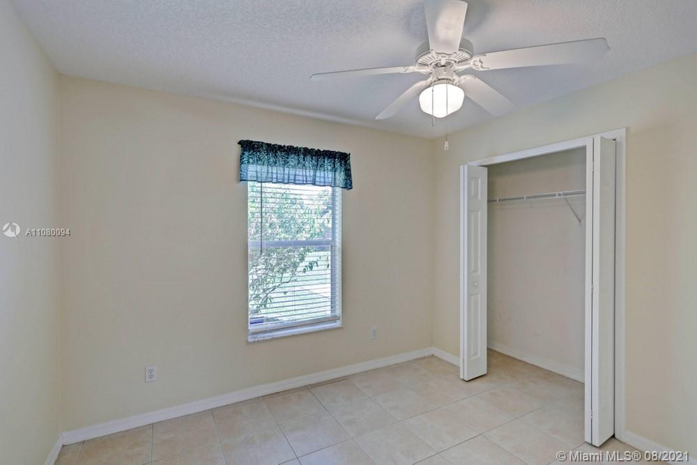 918 Southwest Longfellow Road, Unit 918 Port St. Lucie, FL 34953 - Photo 28 of 53 an empty room with windows and fan
