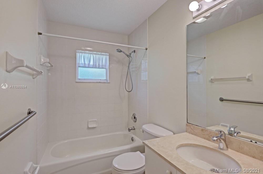 918 Southwest Longfellow Road, Unit 918 Port St. Lucie, FL 34953 - Photo 30 of 53 a bathroom with a granite countertop sink toilet and shower