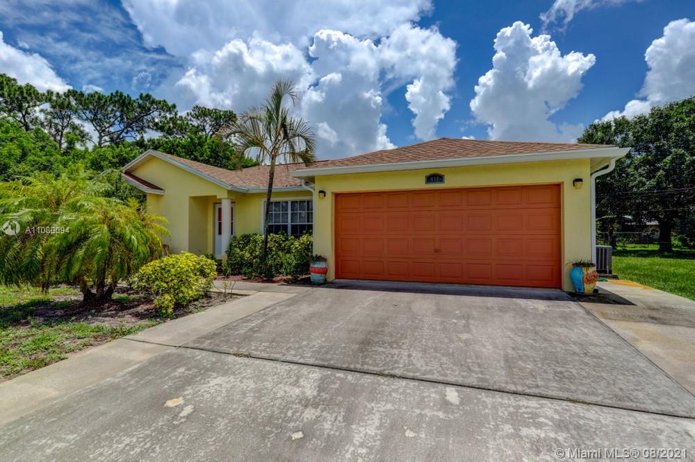 918 Southwest Longfellow Road, Unit 918 Port St. Lucie, FL 34953 - Photo 4 of 53 a front view of a house with garden