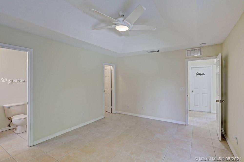 918 Southwest Longfellow Road, Unit 918 Port St. Lucie, FL 34953 - Photo 36 of 53 a view of a room with wooden floor and a ceiling fan