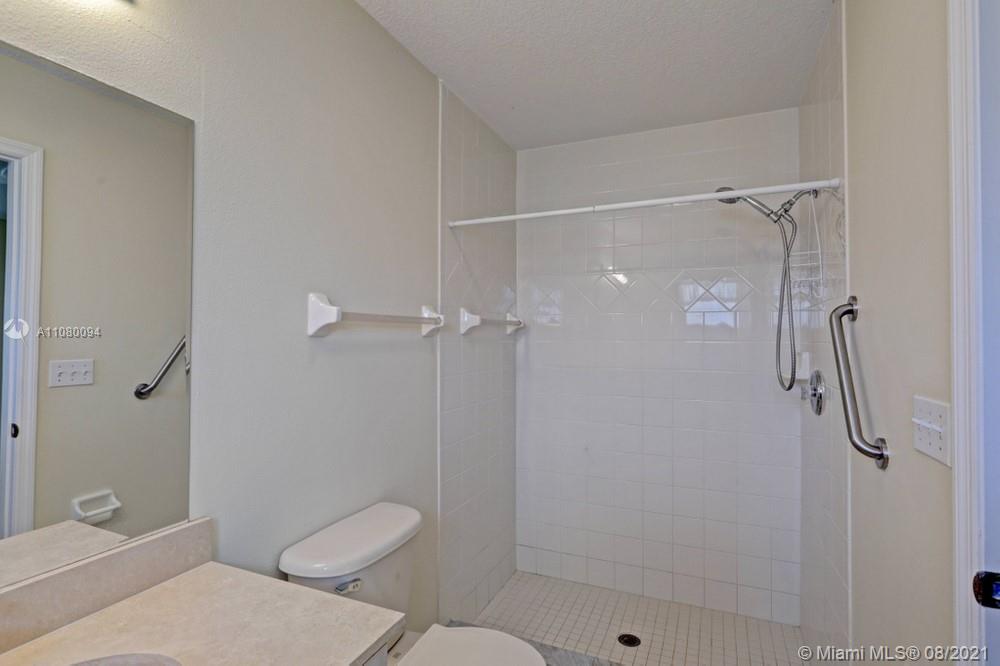 918 Southwest Longfellow Road, Unit 918 Port St. Lucie, FL 34953 - Photo 37 of 53 a bathroom with a shower and toilet