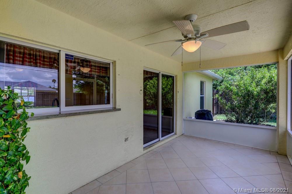 918 Southwest Longfellow Road, Unit 918 Port St. Lucie, FL 34953 - Photo 43 of 53 a view of a livingroom with a ceiling fan and window
