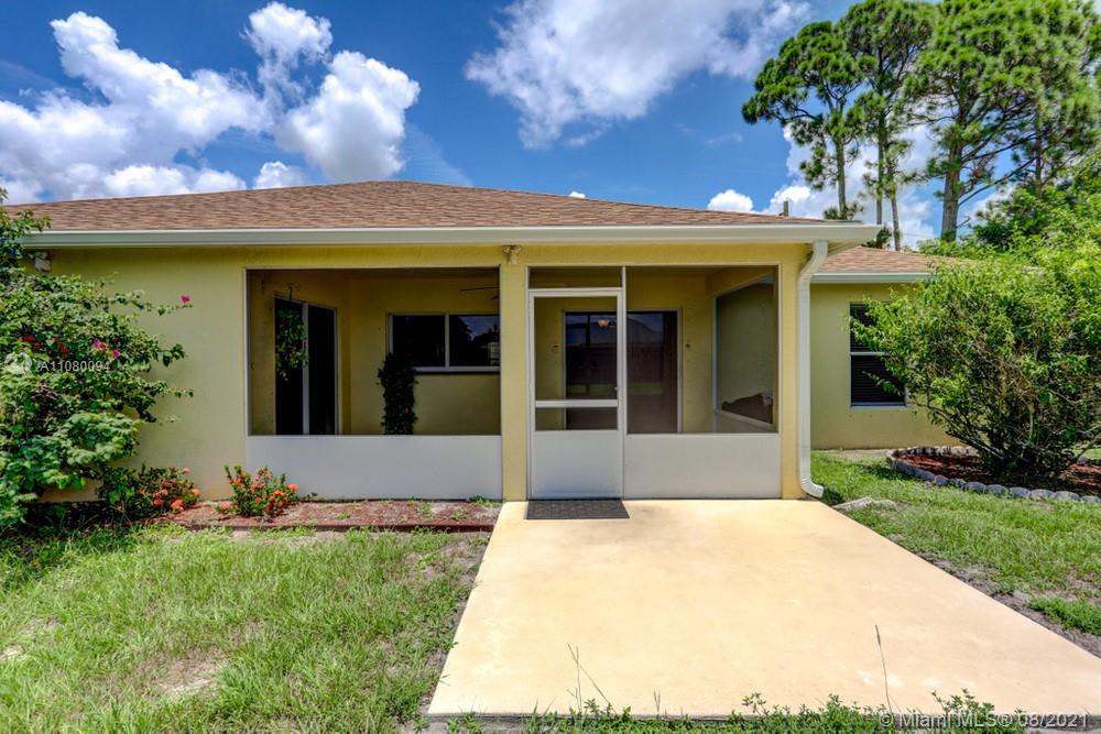 918 Southwest Longfellow Road, Unit 918 Port St. Lucie, FL 34953 - Photo 47 of 53 a view of a white house with a large tree