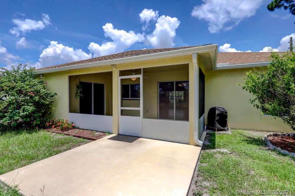 918 Southwest Longfellow Road, Unit 918 Port St. Lucie, FL 34953 - Photo 48 of 53 a front view of a house with a yard