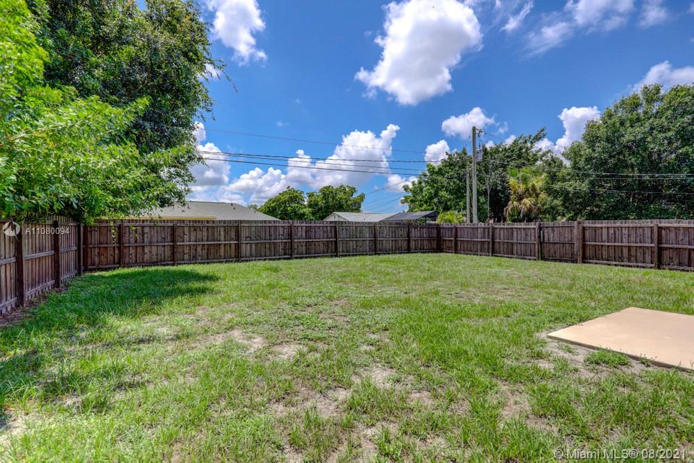 918 Southwest Longfellow Road, Unit 918 Port St. Lucie, FL 34953 - Photo 49 of 53 a view of yard with grass and trees