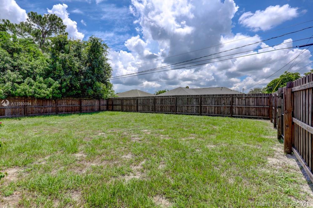 918 Southwest Longfellow Road, Unit 918 Port St. Lucie, FL 34953 - Photo 50 of 53 a view of yard with grass and a garden