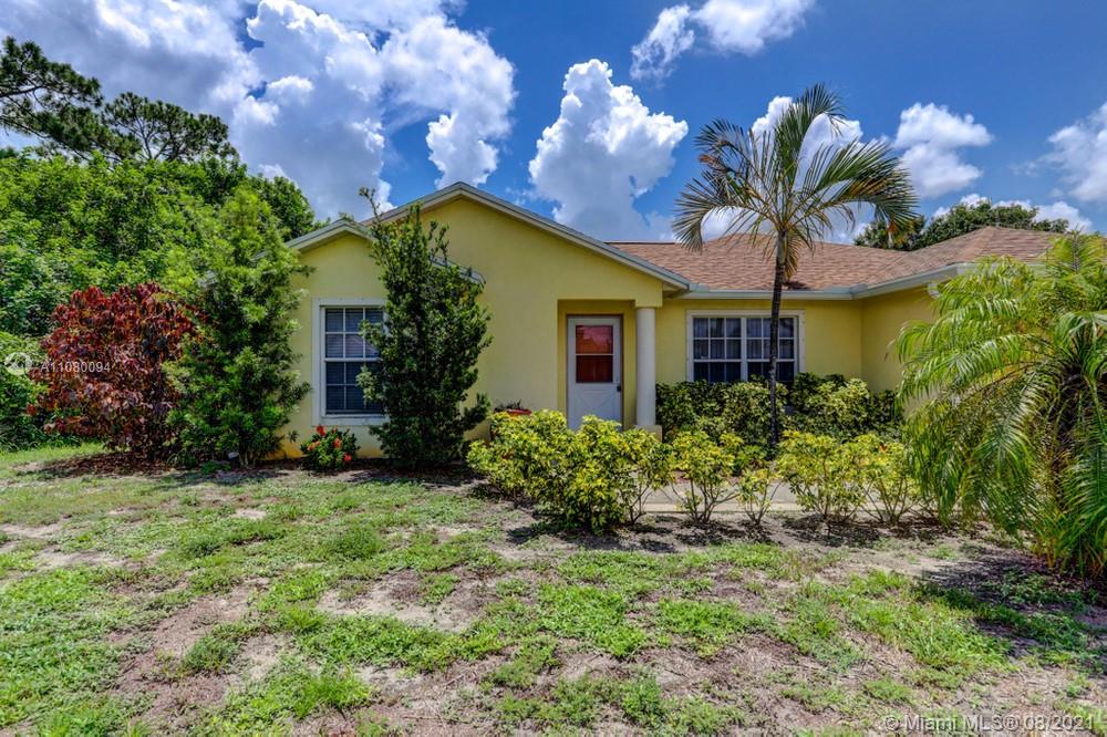 918 Southwest Longfellow Road, Unit 918 Port St. Lucie, FL 34953 - Photo 6 of 53 a view of a house with a yard and potted plants