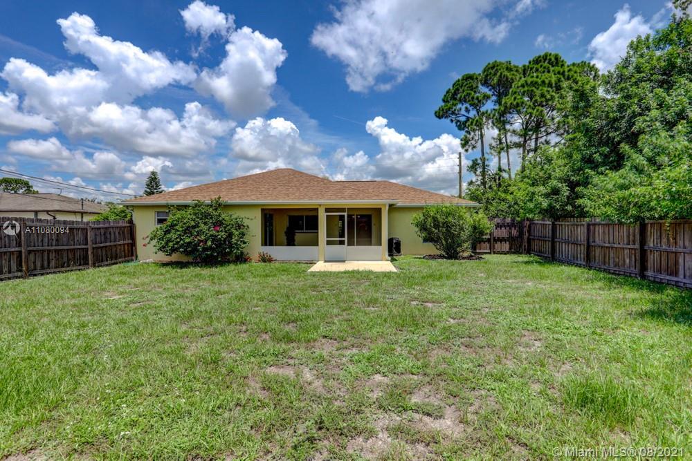 918 Southwest Longfellow Road, Unit 918 Port St. Lucie, FL 34953 - Photo 52 of 53 a view of a house with backyard and garden