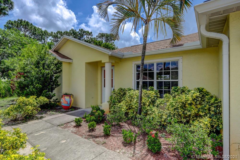 918 Southwest Longfellow Road, Unit 918 Port St. Lucie, FL 34953 - Photo 7 of 53 a front view of a house with plants