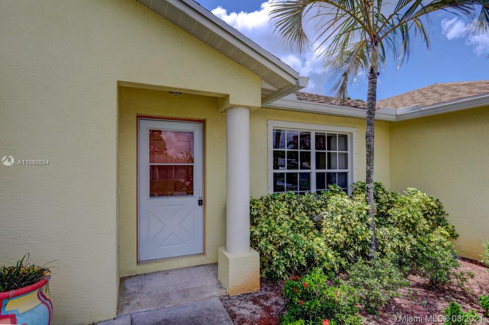 918 Southwest Longfellow Road, Unit 918 Port St. Lucie, FL 34953 - Photo 8 of 53 a front view of a house with a porch