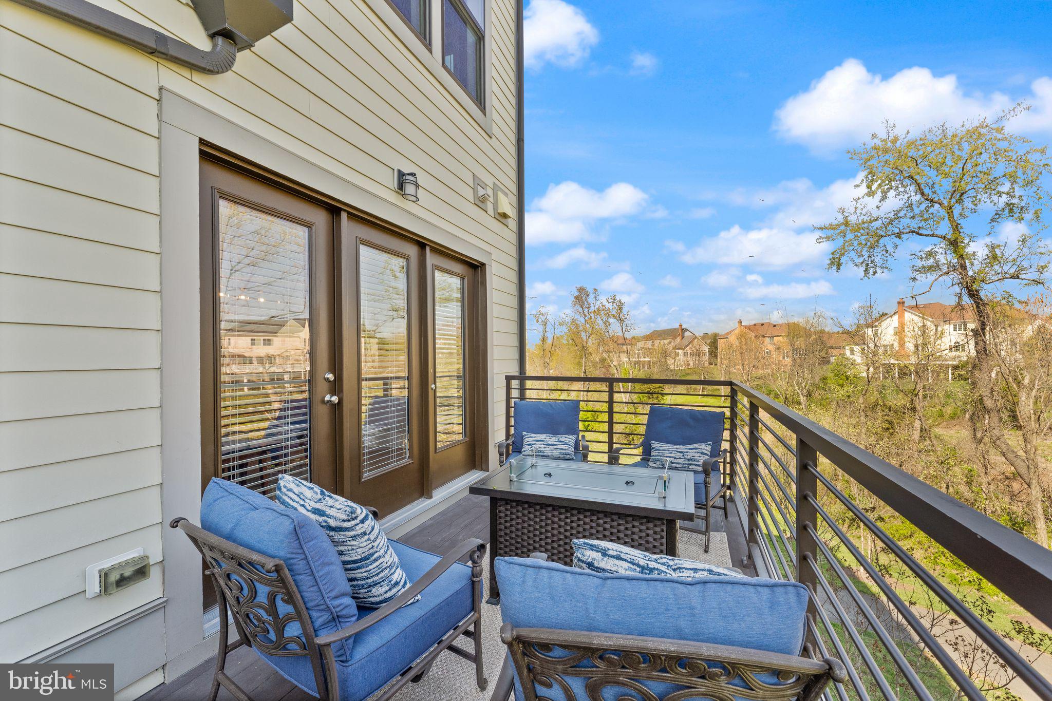 20052 Old Line Terrace Ashburn, VA 20147 - Photo 16 of 67 a view of a balcony with furniture and a floor to ceiling window