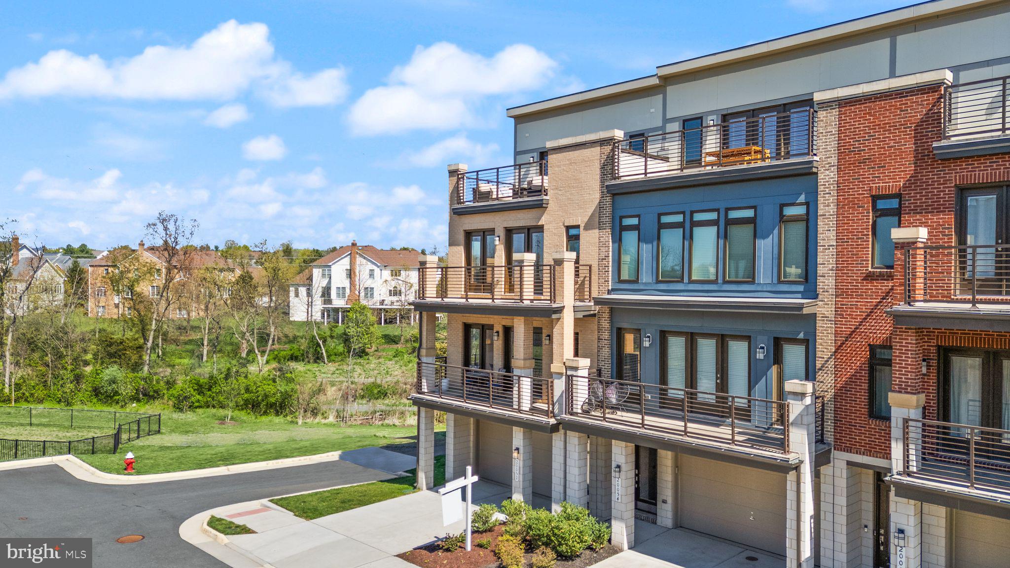 20052 Old Line Terrace Ashburn, VA 20147 - Photo 2 of 67 a front view of a house with a yard
