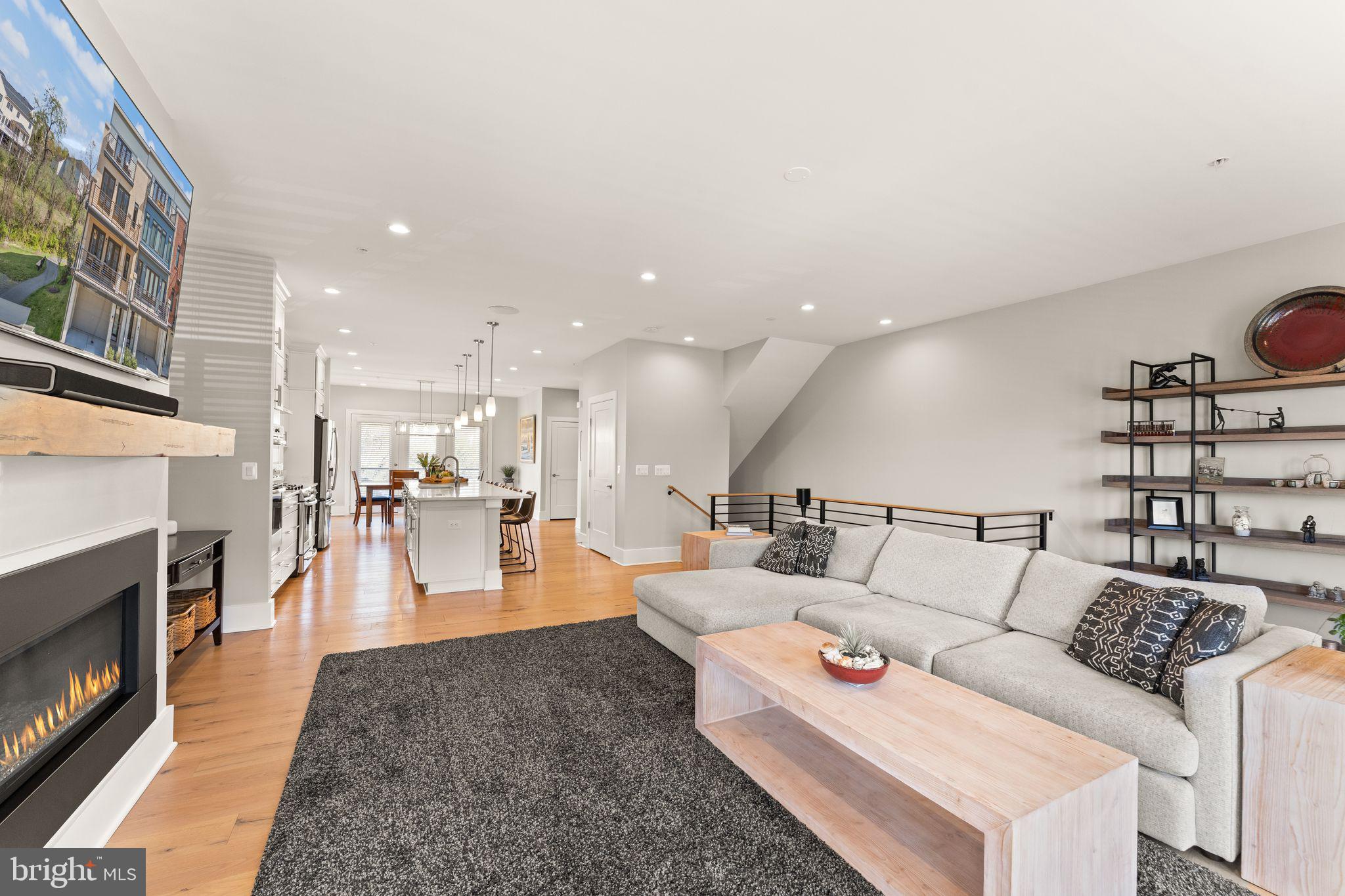 20052 Old Line Terrace Ashburn, VA 20147 - Photo 21 of 67 a living room with furniture and a fireplace with wooden floor