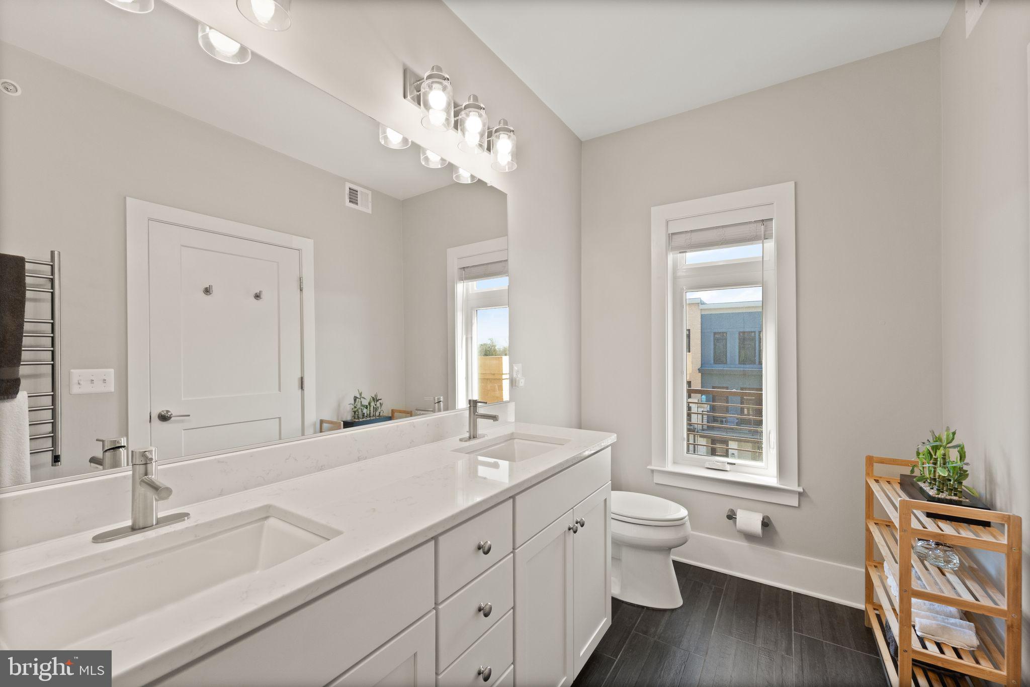 20052 Old Line Terrace Ashburn, VA 20147 - Photo 32 of 67 a bathroom with a double vanity sink a toilet and a window