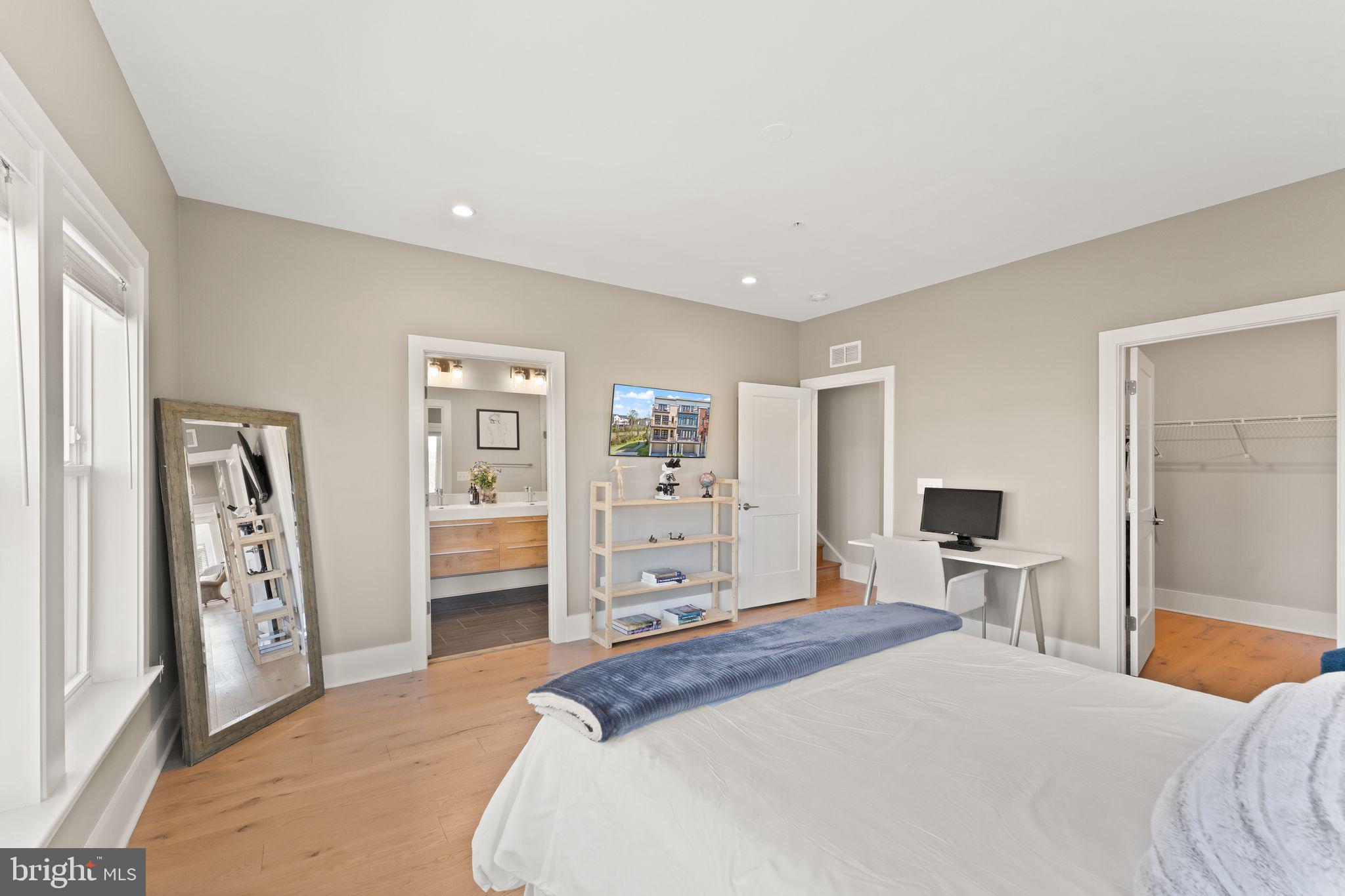 20052 Old Line Terrace Ashburn, VA 20147 - Photo 38 of 67 a bedroom with a large bed and closet