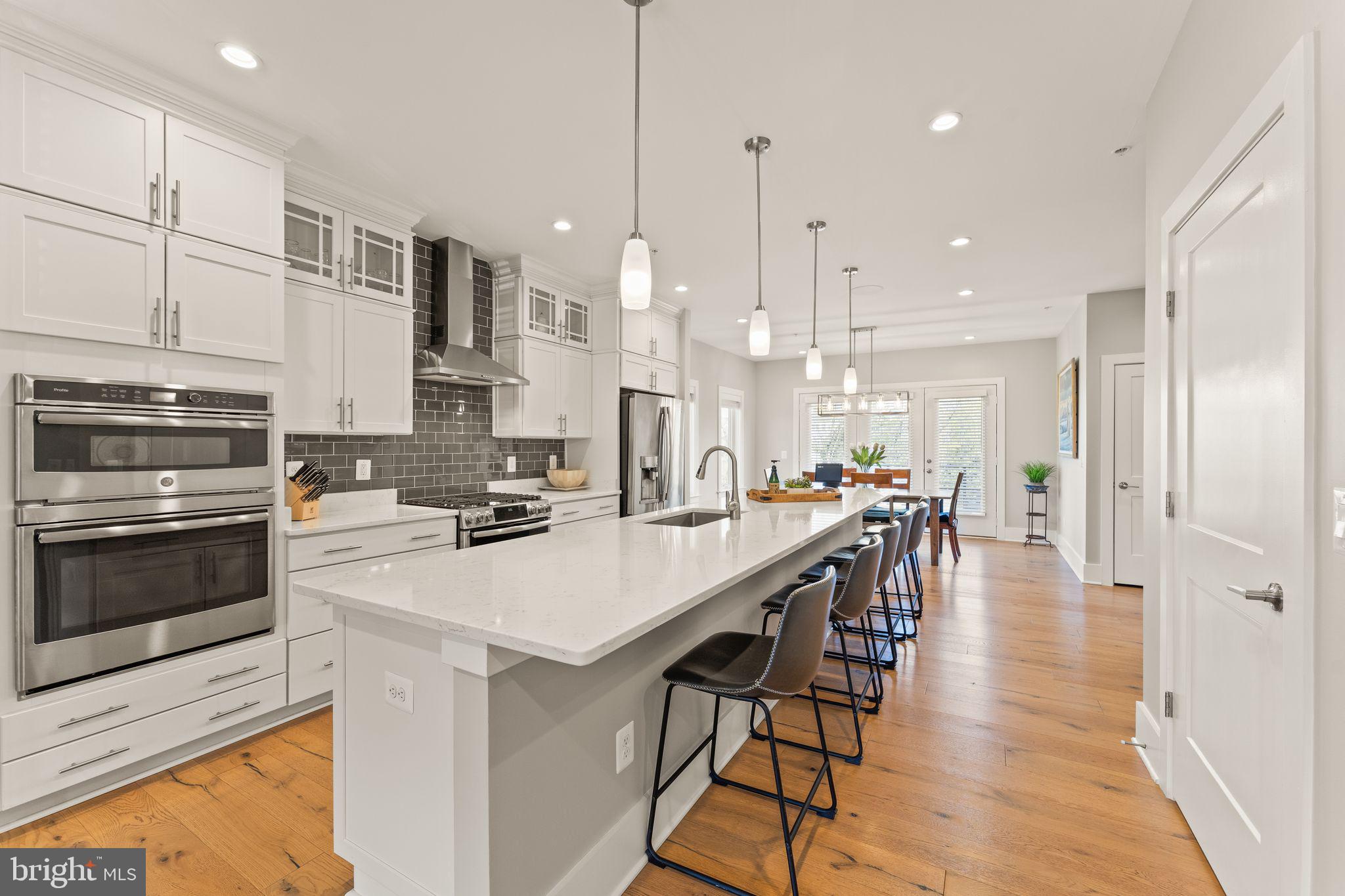20052 Old Line Terrace Ashburn, VA 20147 - Photo 4 of 67 a kitchen with stainless steel appliances kitchen island wooden cabinets and white appliances