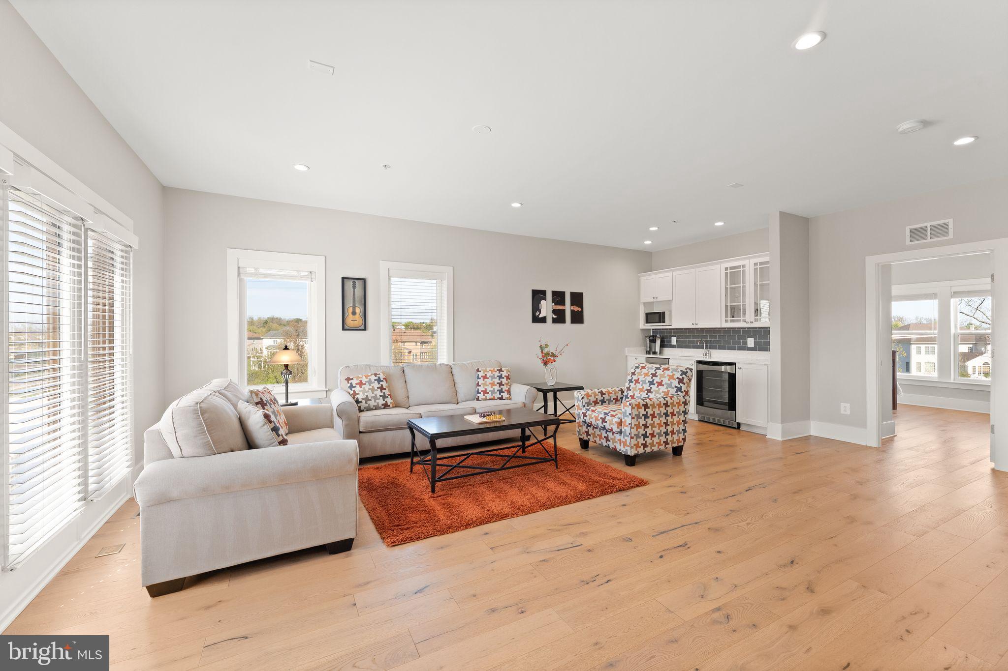 20052 Old Line Terrace Ashburn, VA 20147 - Photo 44 of 67 a living room with furniture kitchen view and a large window