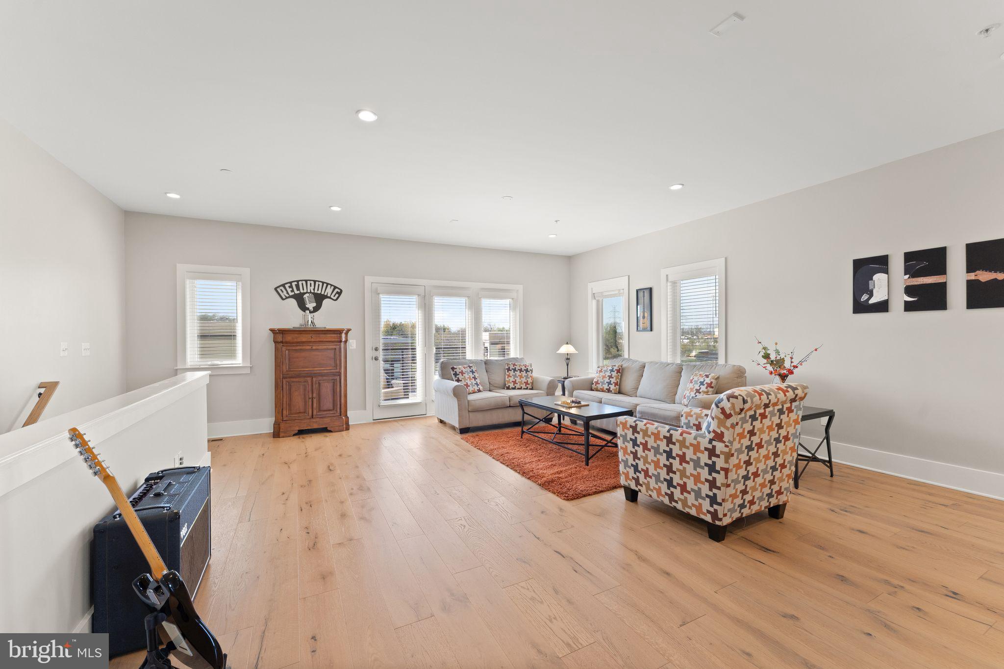 20052 Old Line Terrace Ashburn, VA 20147 - Photo 45 of 67 a living room with furniture and a wooden floor