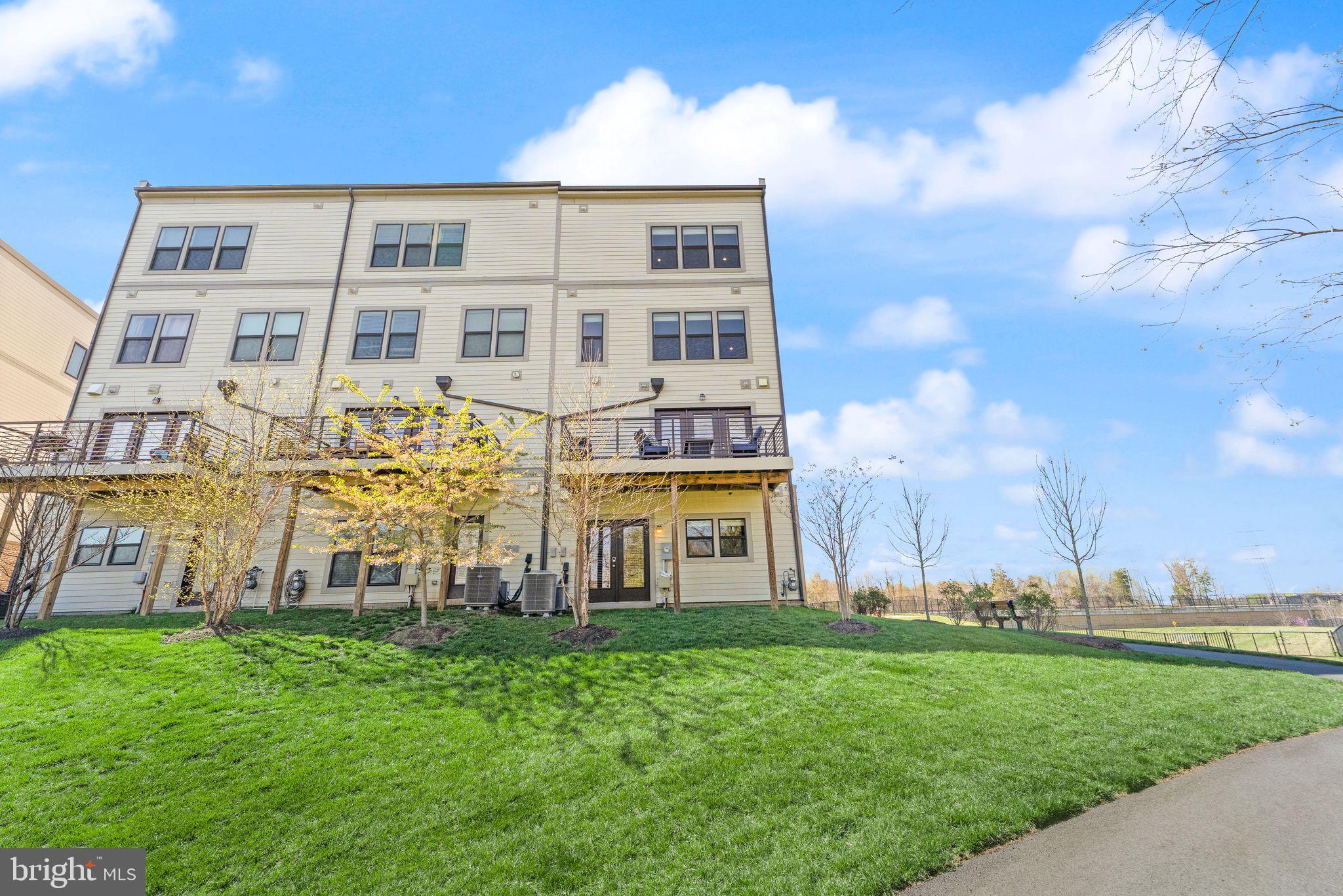 20052 Old Line Terrace Ashburn, VA 20147 - Photo 61 of 67 a front view of a residential apartment building with a yard