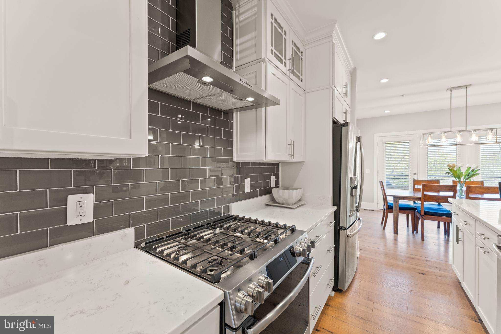 20052 Old Line Terrace Ashburn, VA 20147 - Photo 9 of 67 a kitchen with a stove a sink and a table