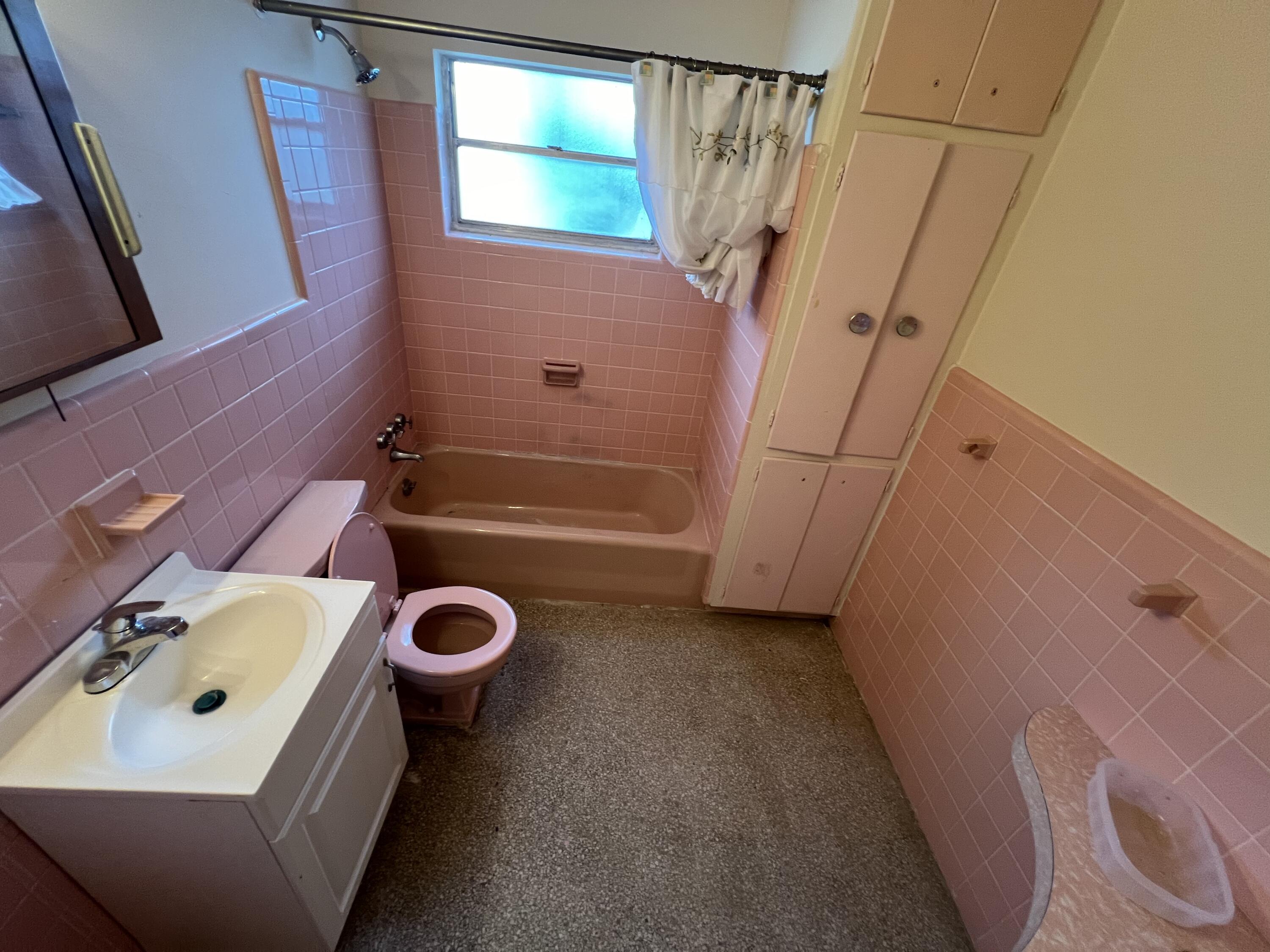 1908 Colonial Road Fort Pierce, FL 34950 - Photo 11 of 14 a bathroom with a sink a toilet and shower
