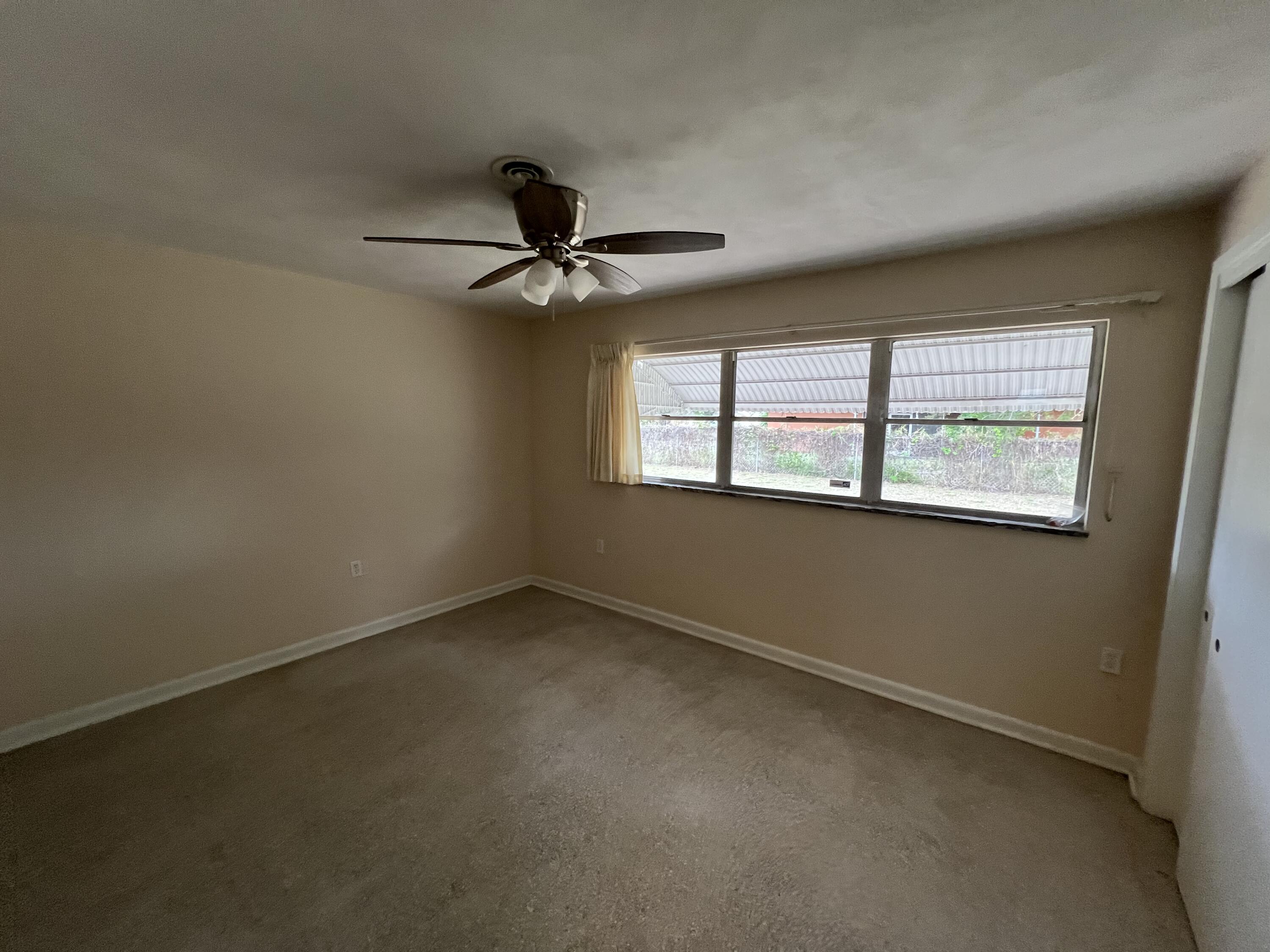 1908 Colonial Road Fort Pierce, FL 34950 - Photo 10 of 14 a view of an empty room with a window