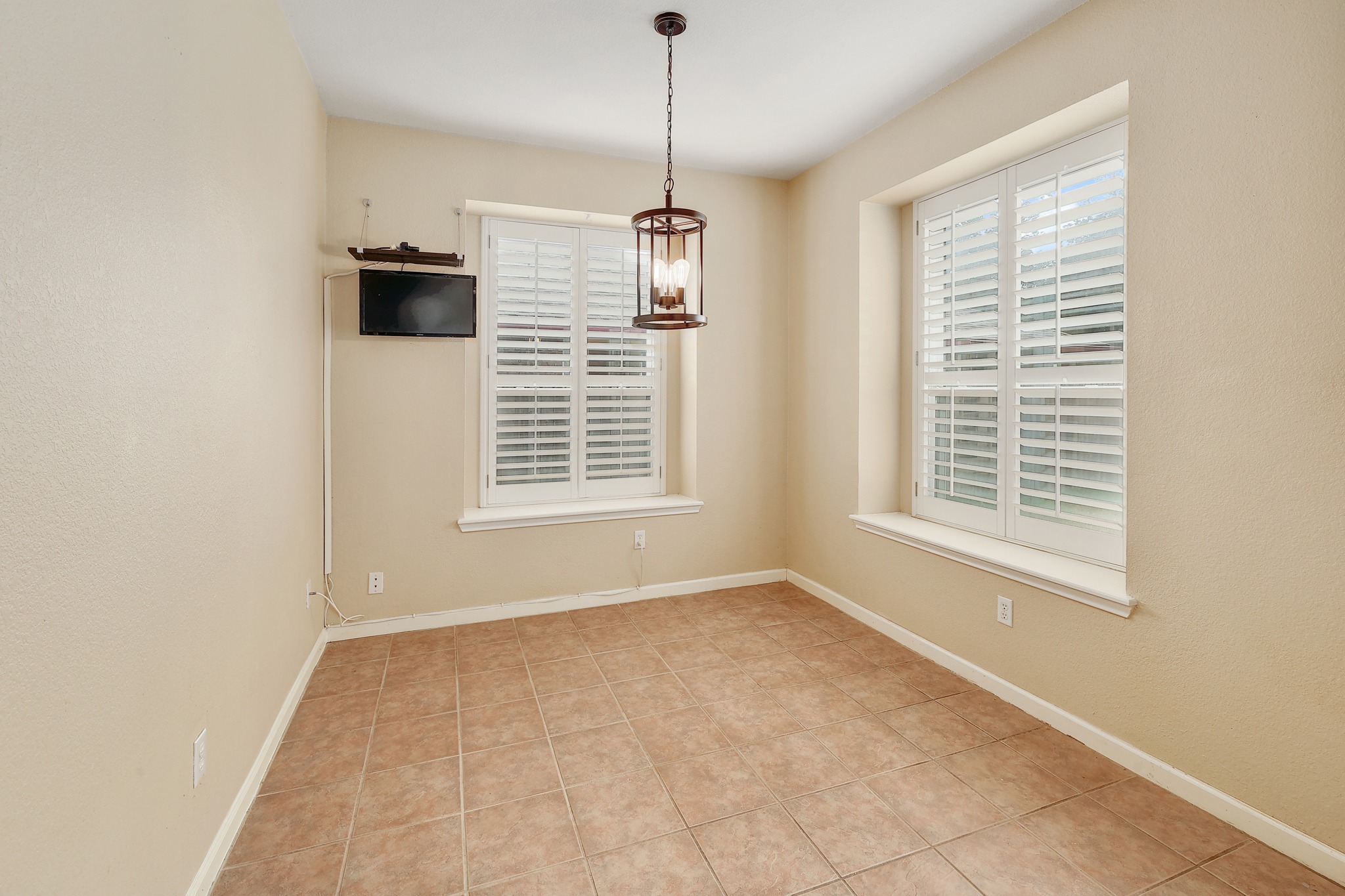 4615 Tello Path Austin, TX 78749 - Photo 12 of 31 Tiled flooring and built-in window shutters frame this versatile dining space.