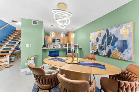 a dining room with furniture and wooden floor