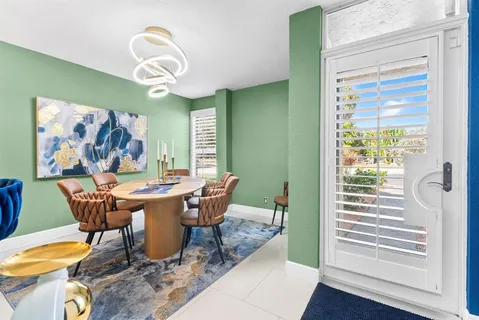 a dining room with furniture a rug and wooden floor