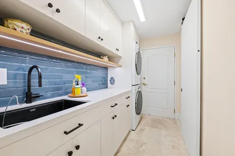 a kitchen with stainless steel appliances a sink and cabinets