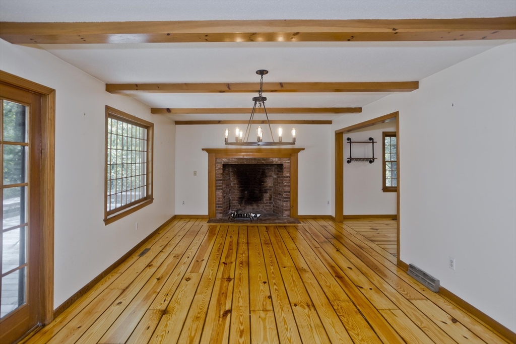 217 Inverness Lane Longmeadow, MA 01106 - Photo 13 of 42 a view of an empty room with wooden floor fireplace and a window