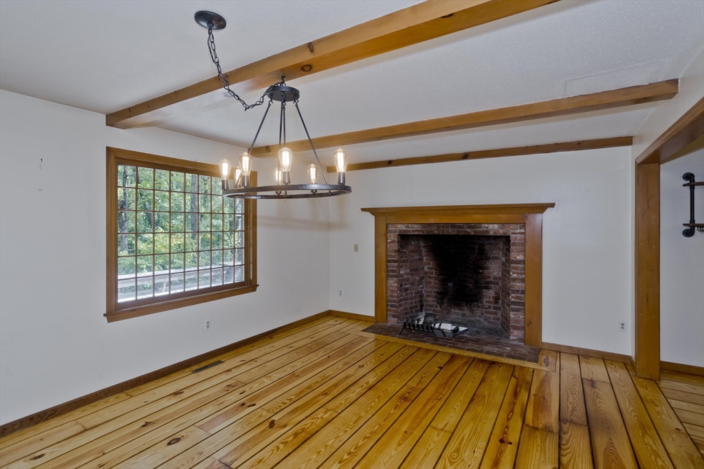 217 Inverness Lane Longmeadow, MA 01106 - Photo 14 of 42 a view of an empty room with wooden floor fireplace and a window