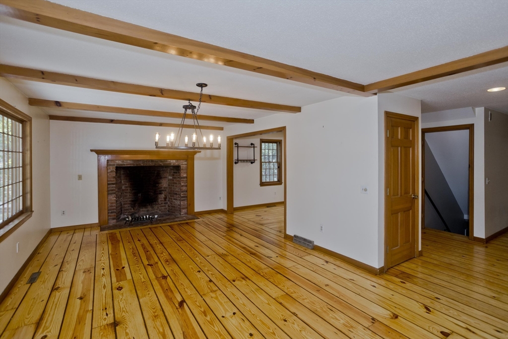 217 Inverness Lane Longmeadow, MA 01106 - Photo 15 of 42 a view of an empty room with wooden floor and a fireplace