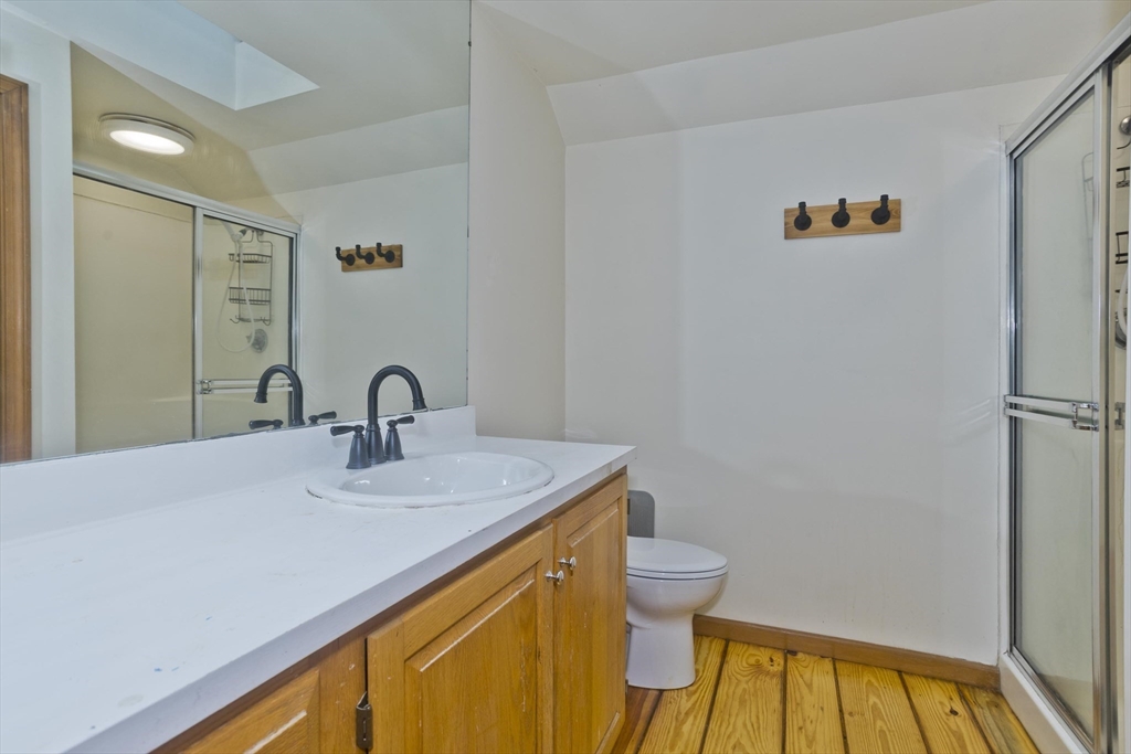 217 Inverness Lane Longmeadow, MA 01106 - Photo 25 of 42 a bathroom with a sink a toilet and a mirror