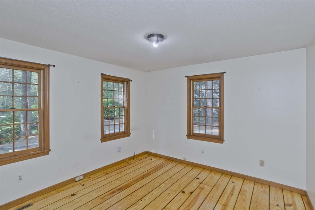 217 Inverness Lane Longmeadow, MA 01106 - Photo 28 of 42 a view of an empty room with wooden floor and a window