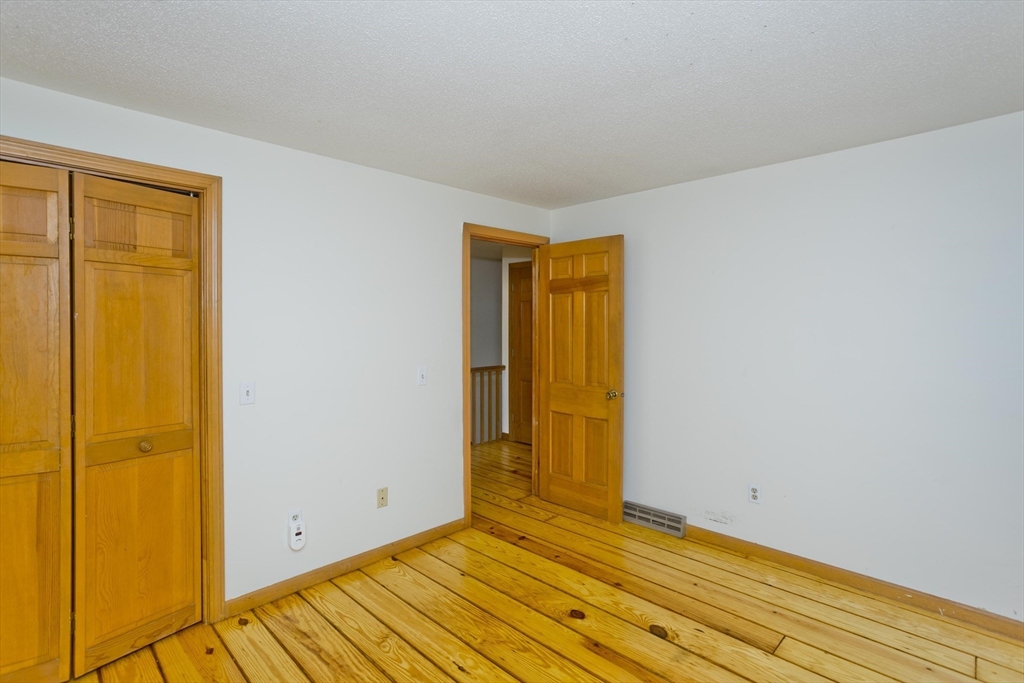 217 Inverness Lane Longmeadow, MA 01106 - Photo 35 of 42 a view of an empty room with wooden floor and a window