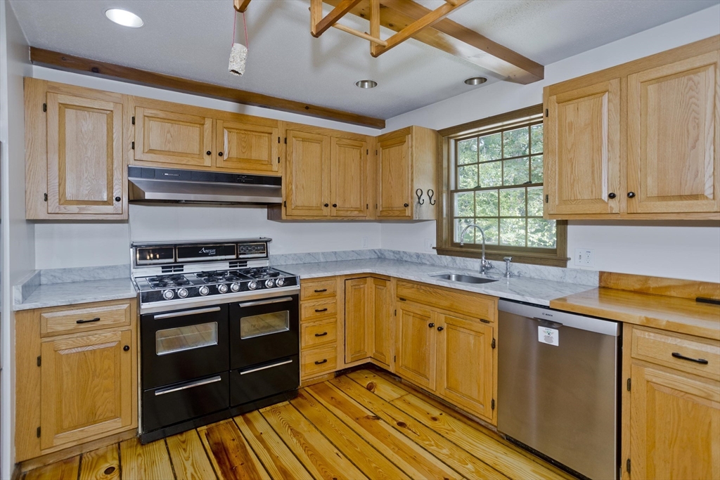 217 Inverness Lane Longmeadow, MA 01106 - Photo 9 of 42 a kitchen with stainless steel appliances granite countertop wooden cabinets and a stove top oven