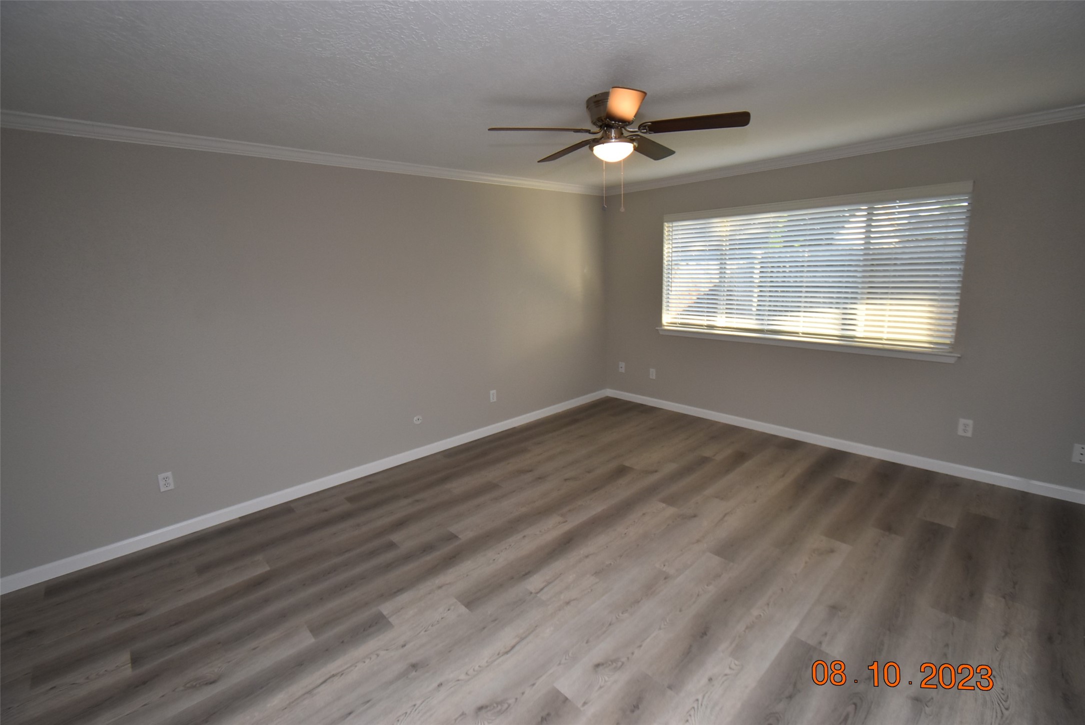 16702 Sheet Bend Way Friendswood, TX 77546 - Photo 15 of 22 an empty room with wooden floor chandelier fan and windows