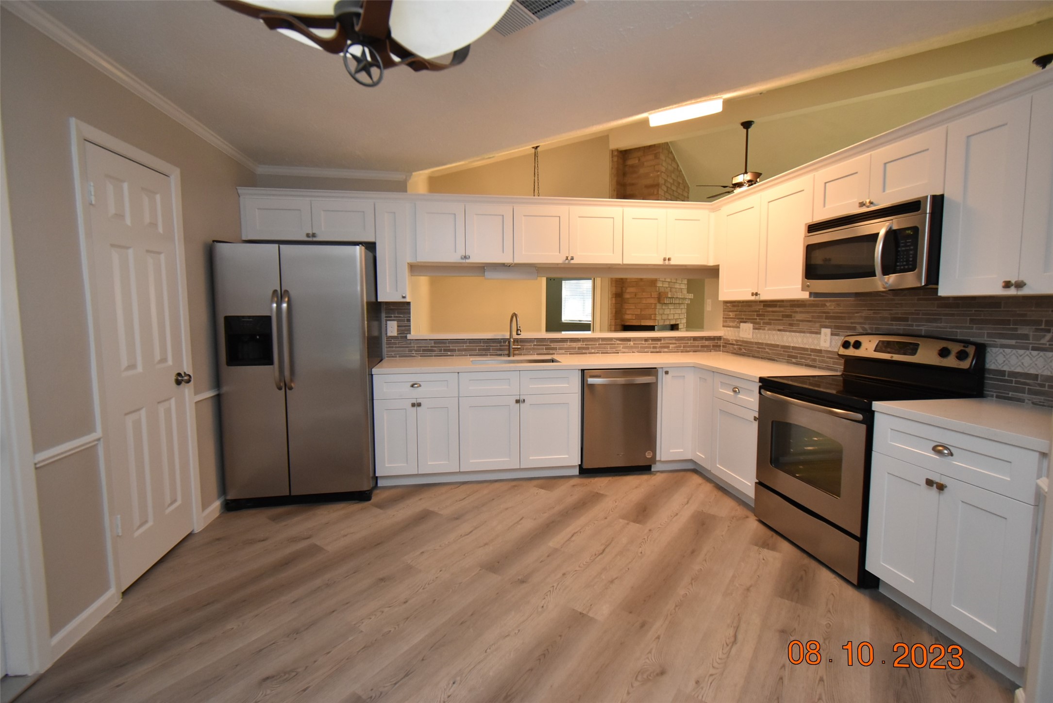 16702 Sheet Bend Way Friendswood, TX 77546 - Photo 3 of 22 a kitchen with a sink cabinets stainless steel appliances and a window
