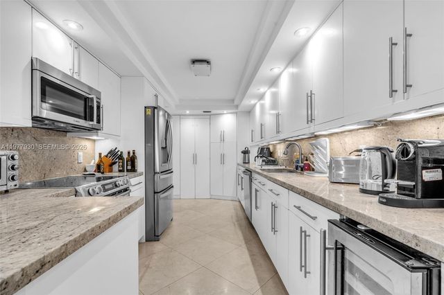 a kitchen with counter top space cabinets and stainless steel appliances