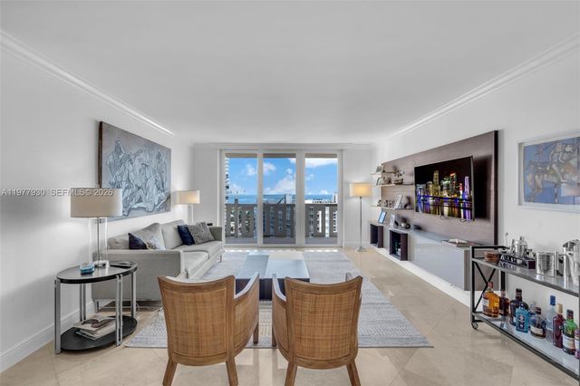 a living room with furniture a flat screen tv and a large window