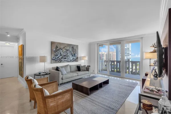 a living room with furniture a flat screen tv and a large window