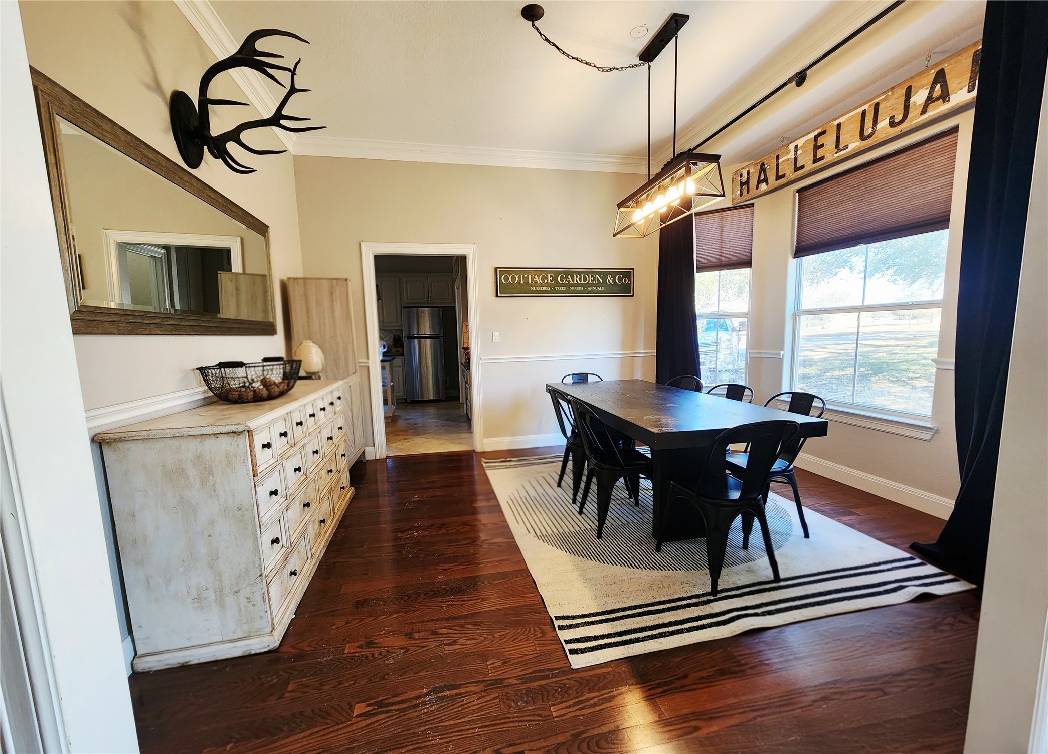 152 Silver Hawk Court Dripping Springs, TX 78620 - Photo 5 of 31 a view of a dining room with furniture window and wooden floor