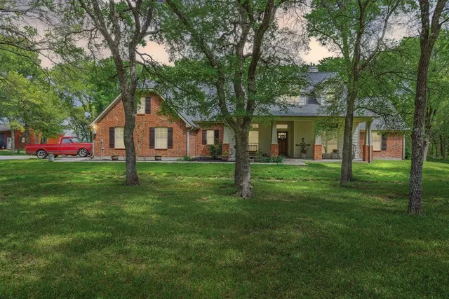 a front view of house with yard and green space
